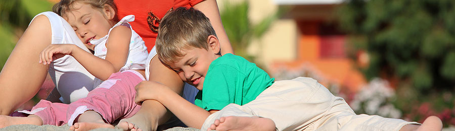 a family sitting in the grass